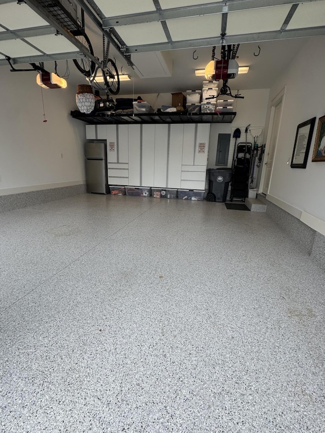 360 Jack Knife Dr, Inlet Beach, FL 32461 - garage featuring freestanding refrigerator, electric panel, and a garage door opener