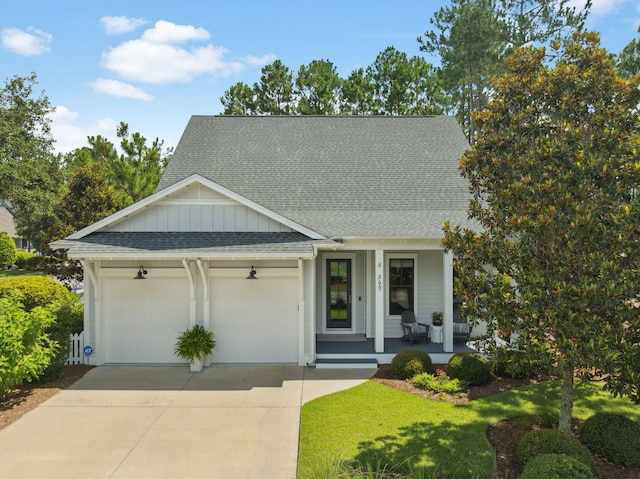 360 Jack Knife Dr, Inlet Beach, FL 32461 - view of front of property featuring a porch, a shingled roof, an attached garage, concrete driveway, and board and batten siding