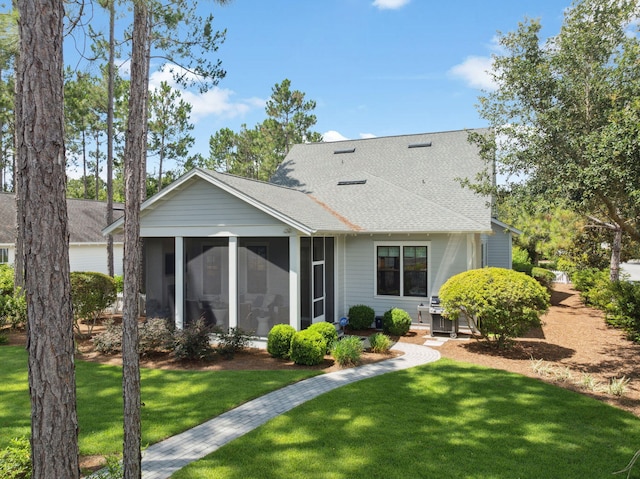 360 Jack Knife Dr, Inlet Beach, FL 32461 - rear view of property featuring a sunroom, roof with shingles, and a lawn