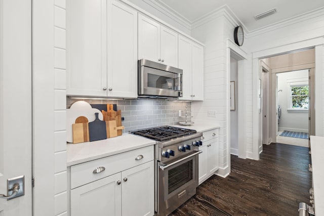 360 Jack Knife Dr, Inlet Beach, FL 32461 - kitchen featuring appliances with stainless steel finishes, crown molding, dark wood finished floors, tasteful backsplash, and light countertops