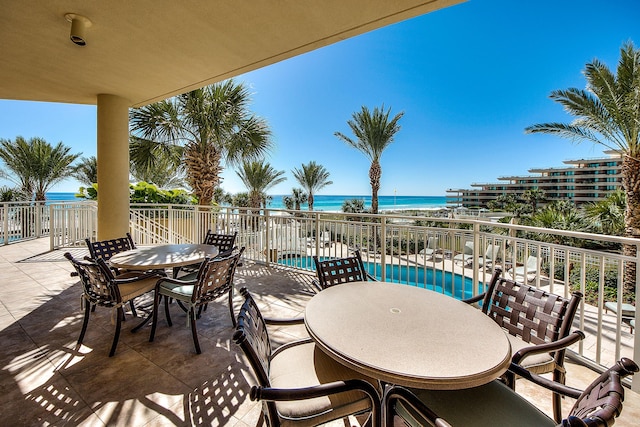 219 Scenic Gulf Dr Unit 930, Miramar Beach, FL 32550 - view of patio / terrace featuring outdoor dining space, a water view, and a community pool