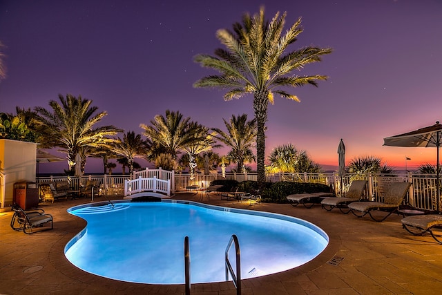 219 Scenic Gulf Dr Unit 930, Miramar Beach, FL 32550 - pool at dusk featuring a patio and a community pool