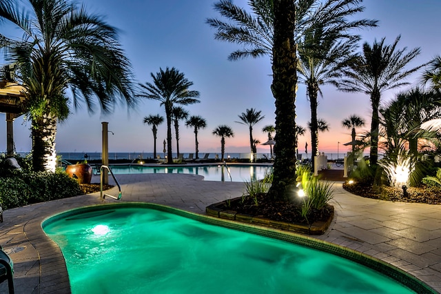 219 Scenic Gulf Dr Unit 930, Miramar Beach, FL 32550 - pool at dusk with a community pool and a water view