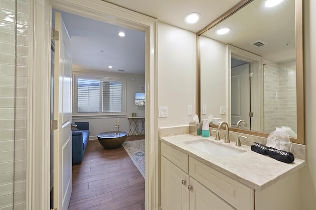 219 Scenic Gulf Dr Unit 930, Miramar Beach, FL 32550 - bathroom with wood finished floors, vanity, and recessed lighting