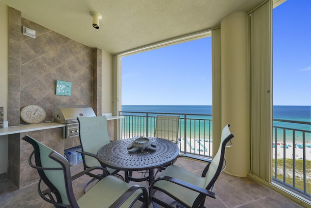 219 Scenic Gulf Dr Unit 930, Miramar Beach, FL 32550 - balcony featuring view of water and beach and exterior kitchen