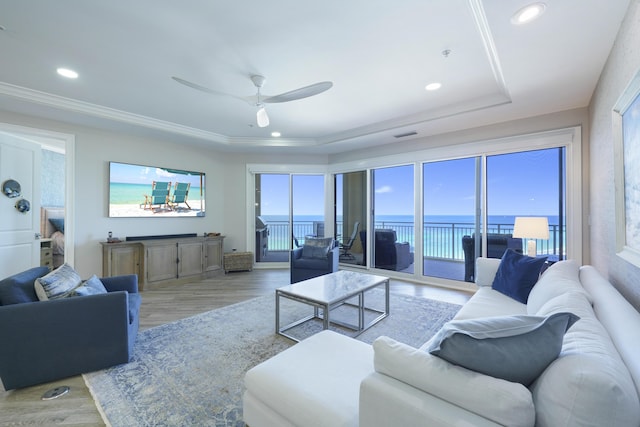 219 Scenic Gulf Dr Unit 930, Miramar Beach, FL 32550 - living room with a tray ceiling, light wood-style floors, recessed lighting, a ceiling fan, and crown molding
