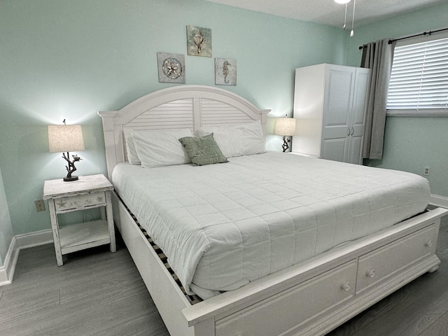 8743 Thomas Dr Unit 924, Panama City Beach, FL 32408 - bedroom with wood finished floors and baseboards