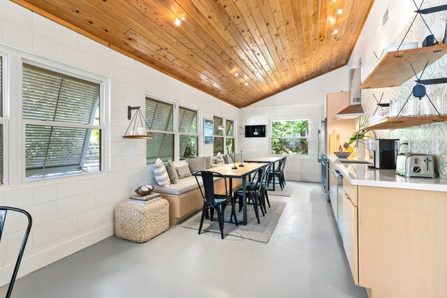 41 E Grove Ave, Santa Rosa Beach, FL 32459 - dining space with concrete floors, lofted ceiling, wood ceiling, and concrete block wall