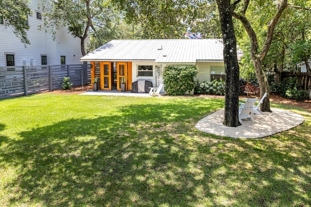 41 E Grove Ave, Santa Rosa Beach, FL 32459 - rear view of property with a fenced backyard, a metal roof, and a patio