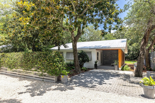 41 E Grove Ave, Santa Rosa Beach, FL 32459 - view of front of house with decorative driveway and a metal roof
