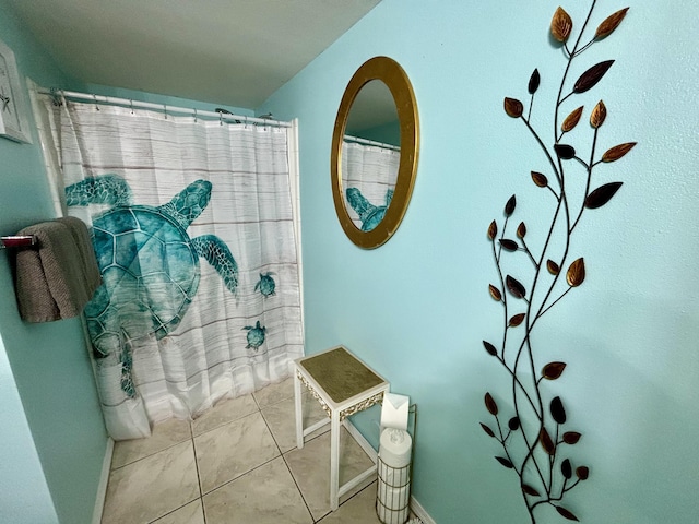 201 S Stillman St Unit 107, Pensacola, FL 32505 - bathroom with baseboards and a shower with shower curtain