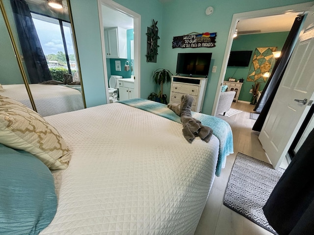 201 S Stillman St Unit 107, Pensacola, FL 32505 - bedroom featuring wood finished floors and ensuite bath