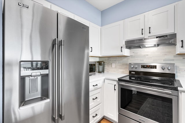 780 Sundial Ct Unit 2001, Fort Walton Beach, FL 32548 - kitchen with stainless steel appliances, extractor fan, white cabinets, and decorative backsplash