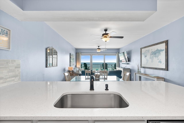 780 Sundial Ct Unit 2001, Fort Walton Beach, FL 32548 - kitchen with open floor plan, ceiling fan, and light stone counters