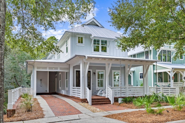 117 W Okeechobee, Santa Rosa Beach, FL 32459 - modern inspired farmhouse featuring board and batten siding, covered porch, an attached carport, driveway, and a metal roof