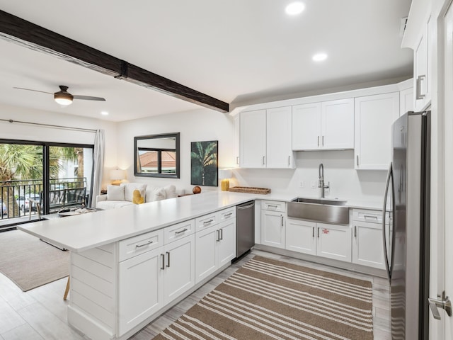 3604 E County Highway 30a Unit D5, Santa Rosa Beach, FL 32459 - kitchen with a peninsula, stainless steel appliances, open floor plan, recessed lighting, and white cabinets