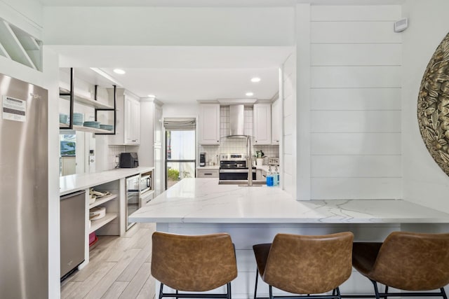 736 Sandpiper Pl Unit 10525, Miramar Beach, FL 32550 - kitchen featuring open shelves, wall chimney exhaust hood, fridge, tasteful backsplash, and recessed lighting