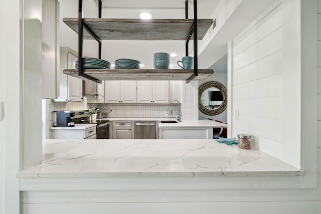 736 Sandpiper Pl Unit 10525, Miramar Beach, FL 32550 - kitchen with stainless steel appliances, tasteful backsplash, light stone countertops, and white cabinets