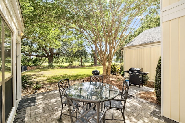 736 Sandpiper Pl Unit 10525, Miramar Beach, FL 32550 - view of patio featuring area for grilling and outdoor dining area