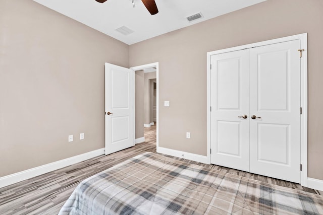 1369 N Beal Ext, Fort Walton Beach, FL 32547 - unfurnished bedroom featuring wood finished floors, a closet, and a ceiling fan