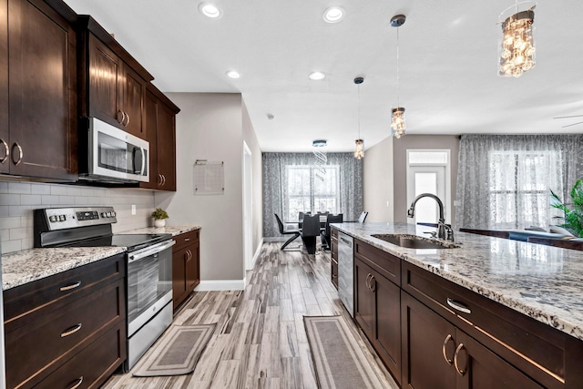 1369 N Beal Ext, Fort Walton Beach, FL 32547 - kitchen featuring appliances with stainless steel finishes, tasteful backsplash, light wood-style floors, pendant lighting, and recessed lighting
