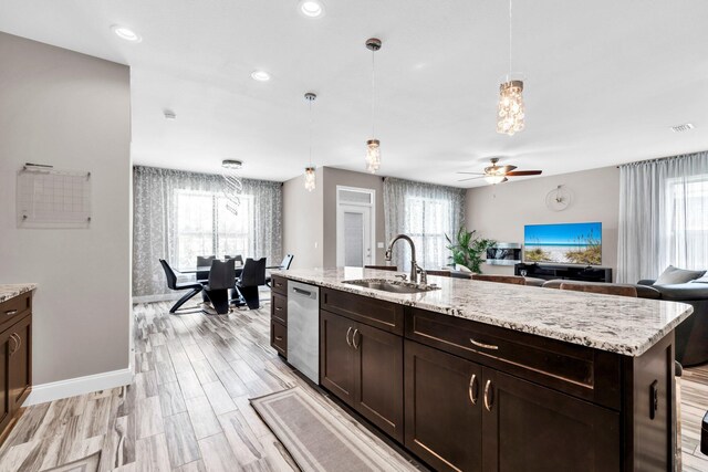 1369 N Beal Ext, Fort Walton Beach, FL 32547 - kitchen featuring stainless steel dishwasher, dark brown cabinets, open floor plan, ceiling fan, and plenty of natural light