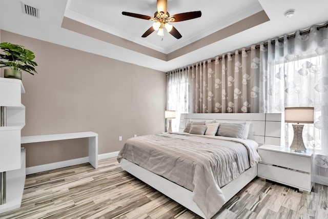 1369 N Beal Ext, Fort Walton Beach, FL 32547 - bedroom with a tray ceiling, wood finished floors, ornamental molding, and ceiling fan