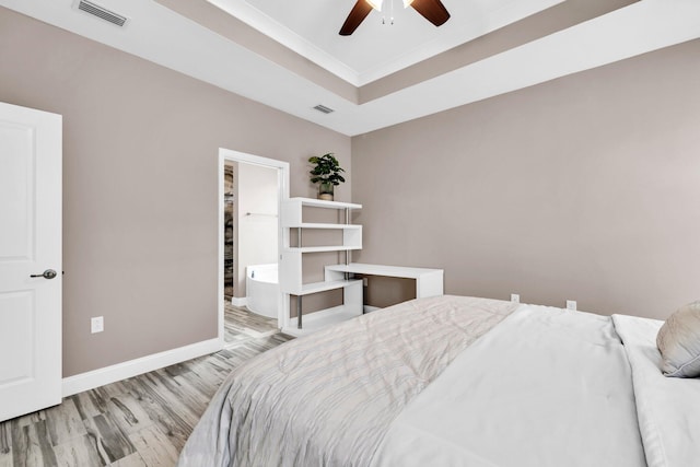 1369 N Beal Ext, Fort Walton Beach, FL 32547 - bedroom featuring wood finished floors, crown molding, a tray ceiling, and a ceiling fan