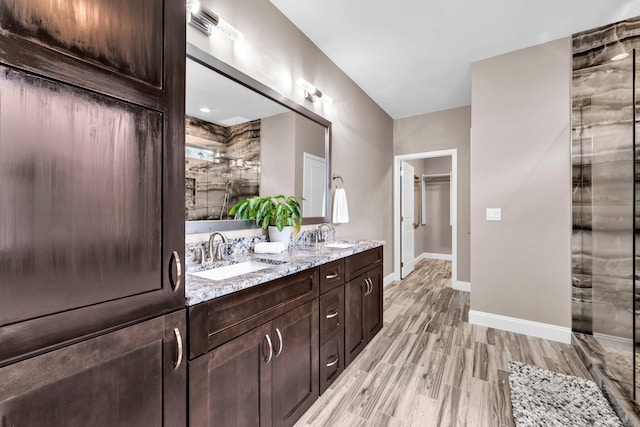 1369 N Beal Ext, Fort Walton Beach, FL 32547 - full bathroom featuring double vanity, an enclosed shower, and wood finished floors