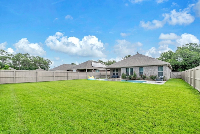 1369 N Beal Ext, Fort Walton Beach, FL 32547 - rear view of property featuring a fenced backyard, a patio area, a pool, and brick siding