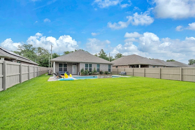 1369 N Beal Ext, Fort Walton Beach, FL 32547 - back of property with a fenced backyard, a patio area, and brick siding