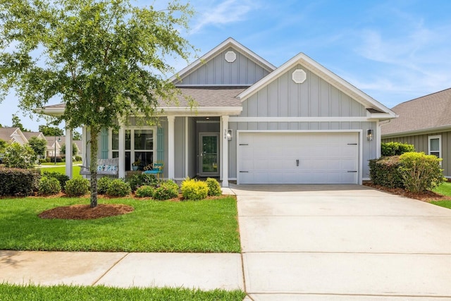 364 Lightning Bug Ln, Freeport, FL 32439 - view of front of home featuring board and batten siding, a front lawn, an attached garage, and driveway