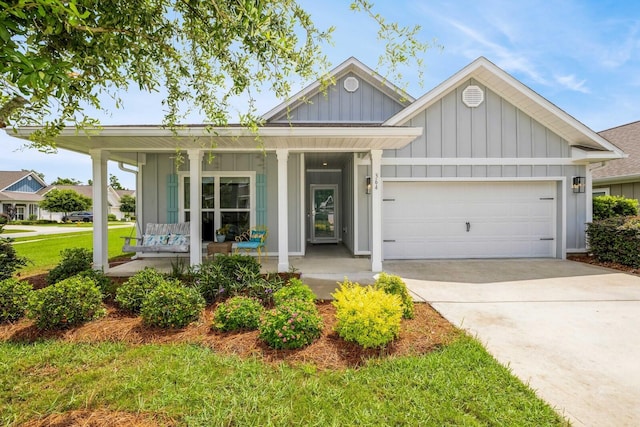 364 Lightning Bug Ln, Freeport, FL 32439 - view of front of property featuring board and batten siding, a porch, an attached garage, concrete driveway, and a front lawn