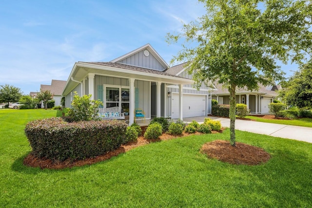 364 Lightning Bug Ln, Freeport, FL 32439 - view of front of house featuring board and batten siding, a porch, driveway, a garage, and a front yard