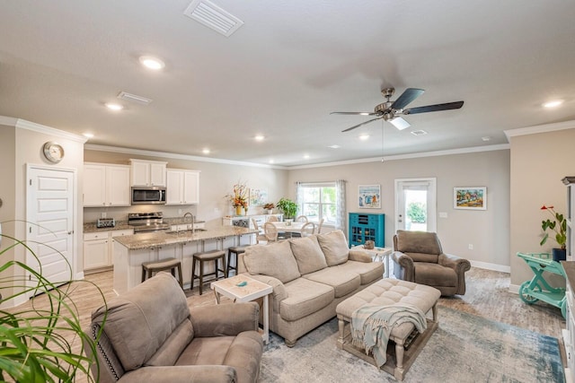 364 Lightning Bug Ln, Freeport, FL 32439 - living room with ceiling fan, recessed lighting, crown molding, and light wood-style flooring