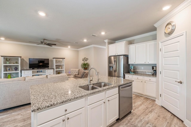 364 Lightning Bug Ln, Freeport, FL 32439 - kitchen with appliances with stainless steel finishes, ceiling fan, ornamental molding, a kitchen island with sink, and white cabinets