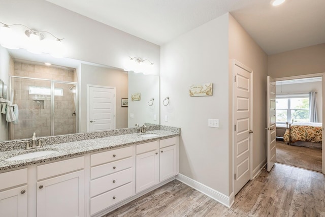 364 Lightning Bug Ln, Freeport, FL 32439 - ensuite bathroom featuring double vanity, a shower stall, and wood finished floors