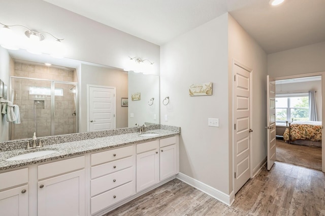 364 Lightning Bug Ln, Freeport, FL 32439 - full bathroom featuring double vanity, connected bathroom, wood finished floors, and a stall shower