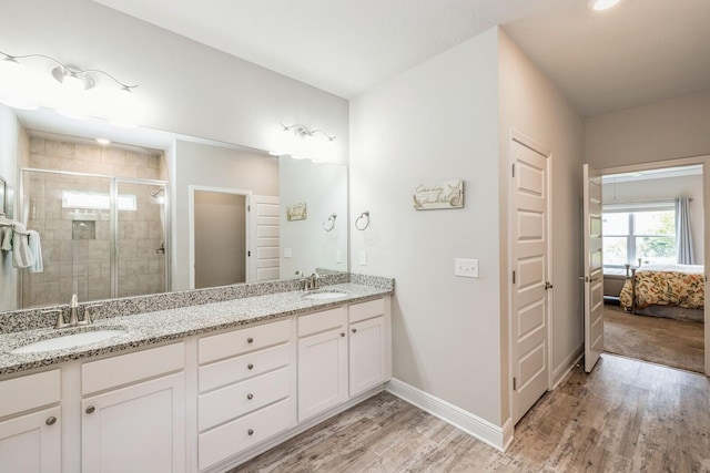 364 Lightning Bug Ln, Freeport, FL 32439 - bathroom with double vanity, wood finished floors, a shower stall, and ensuite bath