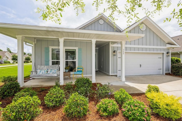 364 Lightning Bug Ln, Freeport, FL 32439 - view of front of property featuring board and batten siding, covered porch, an attached garage, and concrete driveway