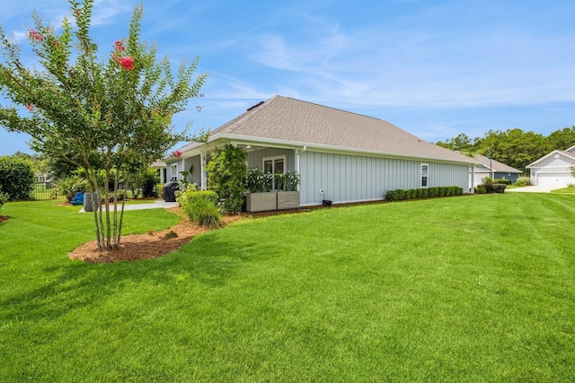 364 Lightning Bug Ln, Freeport, FL 32439 - view of property exterior featuring a lawn, roof with shingles, and board and batten siding