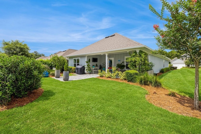 364 Lightning Bug Ln, Freeport, FL 32439 - rear view of house with a patio area, board and batten siding, a yard, and roof with shingles