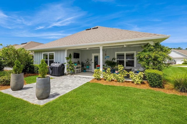 364 Lightning Bug Ln, Freeport, FL 32439 - back of house with ceiling fan, board and batten siding, a lawn, a patio area, and roof with shingles