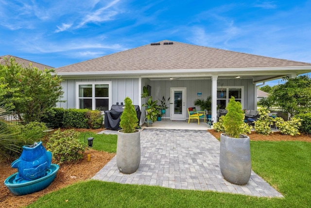 364 Lightning Bug Ln, Freeport, FL 32439 - back of house featuring board and batten siding, a shingled roof, a patio area, a yard, and a ceiling fan