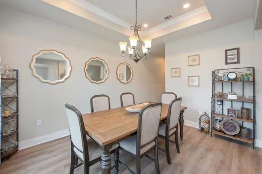 2405 Dakota Way, Crestview, FL 32536 - dining space featuring wood finished floors, a chandelier, a raised ceiling, and recessed lighting