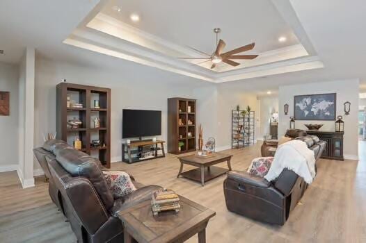 2405 Dakota Way, Crestview, FL 32536 - living area with a tray ceiling, a ceiling fan, light wood-type flooring, ornamental molding, and recessed lighting