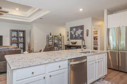 2405 Dakota Way, Crestview, FL 32536 - kitchen featuring stainless steel appliances, open floor plan, light stone counters, white cabinets, and recessed lighting