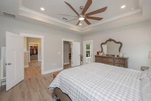 2405 Dakota Way, Crestview, FL 32536 - bedroom featuring a tray ceiling, light wood-type flooring, recessed lighting, crown molding, and a ceiling fan