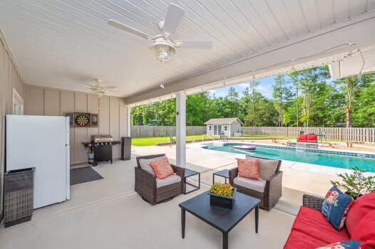 2405 Dakota Way, Crestview, FL 32536 - view of swimming pool with a fenced backyard, an outdoor living space, and a ceiling fan