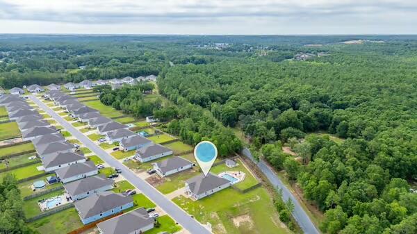 2405 Dakota Way, Crestview, FL 32536 - aerial view of property and surrounding area featuring a heavily wooded area
